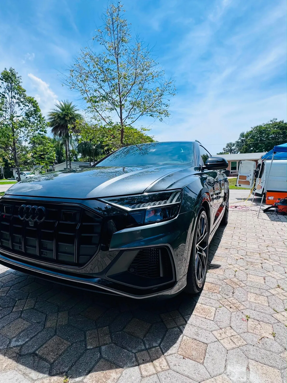 Black Audi Q8 parked in a driveway after a detail