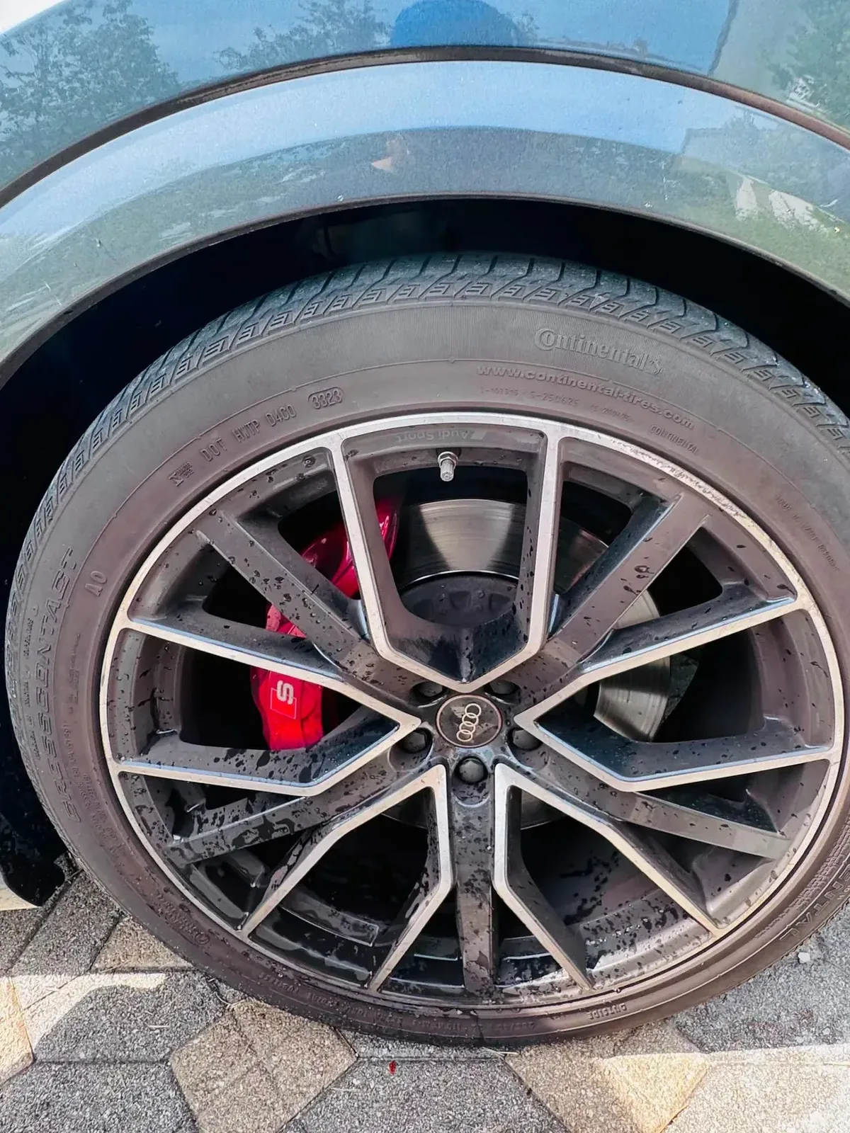 Audi wheel before detailing, dull with water spots and a dirty tire